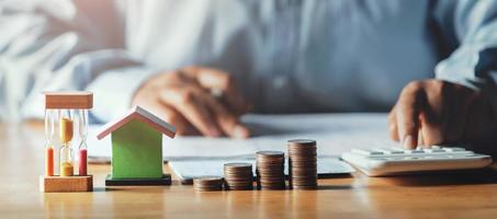 businessman working on desk office with using a calculator to calculate finance accounting concept photo