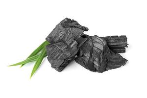 wood natural charcoal with pandan leaf isolate on white background photo
