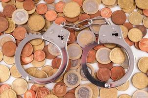 Handcuffs and coins photo