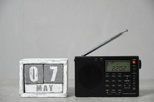 May 07, wooden calendar and radio gray background.Concept for Radio day. photo