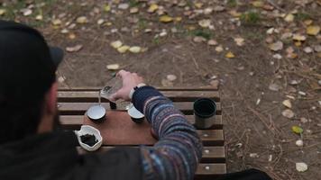 the tea master pours boiling water into the bowls to wash the tea utensils video