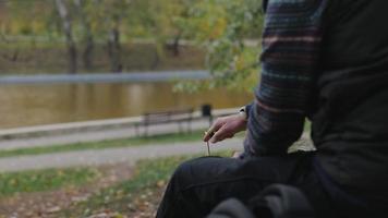 man lights an incense stick with a lighter video