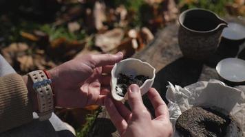 pressed pu-erh tea in a ceramic bowl is demonstrated by a man. chinese tea ceremony concept video