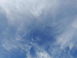 Beautiful white clouds on deep blue sky background. Large bright soft fluffy clouds are cover the entire blue sky. photo