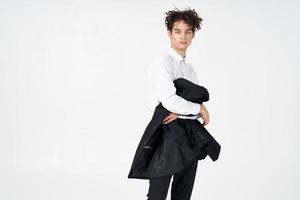 business guy curly hair jacket in hands fashion posing photo