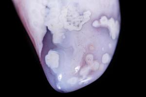 Macro mineral stone Agate pink Persian on a black background photo