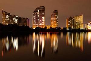 night city with reflection of houses in the river photo