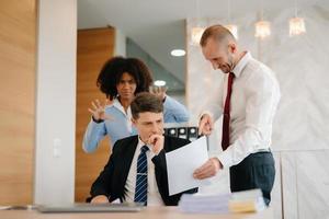 Team thinking of problem solution at office meeting, sad diverse business people group shocked by bad news, upset colleagues in panic after company bankruptcy concept photo