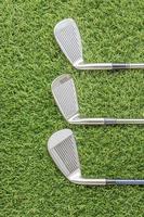 Row of golf club on grass photo