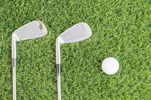 Golf club and Golf ball on green grass photo