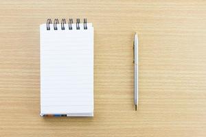 Pen and notepad with blank page photo