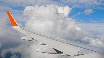 Wing of airplane on sky and cloud on moving, view from airplane cabine video