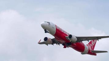 PHUKET, THAILAND FEBRUARY 06, 2023 - Airbus A320, HS CBD of AirAsia taking off at Phuket airport, side view. Jet aircraft departure, climb. Airplane in the sky retracts landing gear. video