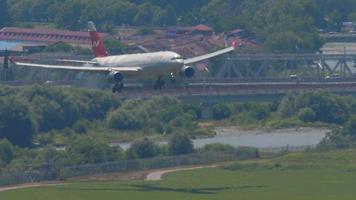 SOCHI, RUSSIA JULY 29, 2022 - Plane Airbus A330 of Nordwind landing at Sochi Airport. Airplane flies on the city. Tourism and travel concept video