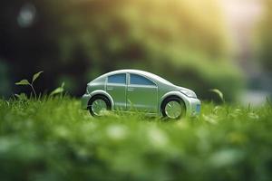 eléctrico coche con verde hoja icono en difuminar césped fondo, ecología y ambiente concepto foto