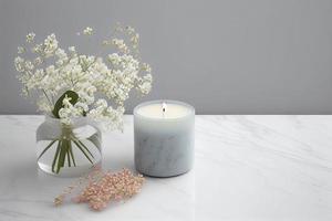 with a lot of copy space, nice gentle background with gypsophila flowers and candle on marble background photo