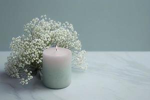 with a lot of copy space, nice gentle background with gypsophila flowers and candle on marble background photo