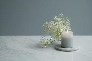 with a lot of copy space, nice gentle background with gypsophila flowers and candle on marble background photo