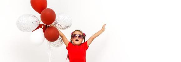 Little girl with balloons on a white background photo