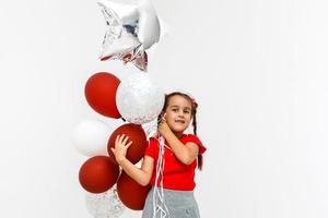 Beautiful little girl, with balls on white background photo