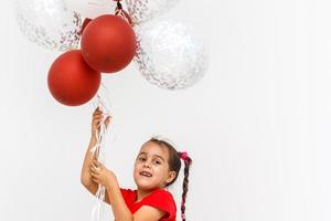 Beautiful little girl, with balls on white background photo