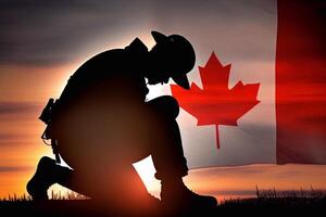 The flag of Canada and the silhouette of a soldier. photo