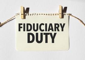 Card with text fiduciary duty . Diagram and white background photo