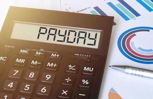 Word payday on calculator. Business and finance concept. photo