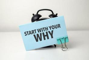 start with your why is written in a blue sticker near a black alarm clock photo