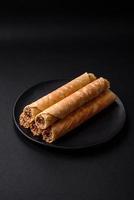 Delicious crispy wafer rolls with cream filling with nuts photo
