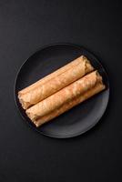 Delicious crispy wafer rolls with cream filling with nuts photo