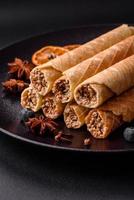 Delicious crispy wafer rolls with cream filling with nuts photo