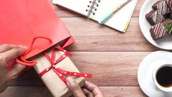 Top view of man hand placing gift box inside a bag video