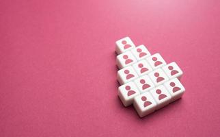 Blocks with people in the shape of an arrow. Cooperation teamwork. Forming into an organized group. Consolidation, strengthening. Hierarchy in the team, distribution of roles. photo