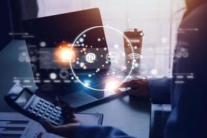 Contact us or Customer support hotline people connect. Businessman using a laptop and touching on virtual screen contact icons email, address, live chat, internet wifi photo