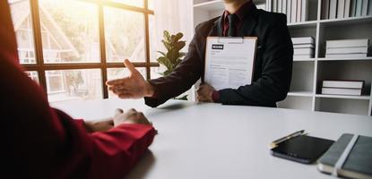 Close up view of job interview in office, focus on resume writing tips, employer reviewing good cv of prepared skilled applicant, recruiter considering application, hr manager making hiring decision photo