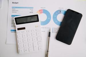 Financial analysts analyze business financial reports on a digital tablet planning investment project during a discussion at a meeting of corporate showing the results of their successful teamwork. photo