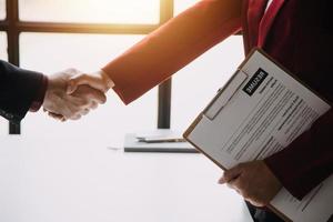 Close up view of job interview in office, focus on resume writing tips, employer reviewing good cv of prepared skilled applicant, recruiter considering application, hr manager making hiring decision photo