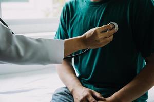 Male patient having consultation with doctor or psychiatrist who working on diagnostic examination on men's health disease or mental illness in medical clinic or hospital mental health service center photo