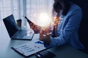 Hand of businessman holding illuminated light bulb with network connection line, idea, innovation and inspiration concept. concept creativity with bulbs that shine glitter. photo