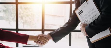 Close up view of job interview in office, focus on resume writing tips, employer reviewing good cv of prepared skilled applicant, recruiter considering application, hr manager making hiring decision photo