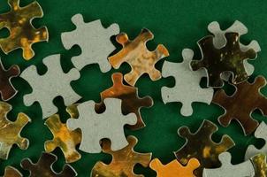 Puzzle pieces on green background photo