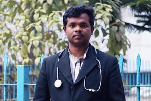 Rangpur, Bangladesh 2023. Young Doctor with Black Coat and Diamond Blood Pressure Machine. Healthcare and medical concept. Homeopathy Doctor Treatment in Asia. Dr Hafizul Islam Santo photo