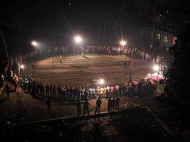 Rangpur, Bangladesh 2023. Local Stadium for cricket match.People around the playground in Night of top view.There are crowds around the middle of the night to watch the game.Top view Arial photo