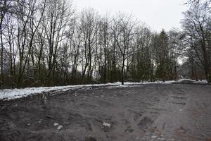 Muddy Forest Parking Lot in Winter photo