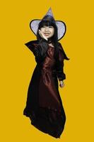 Portrait of asian little girl wear witch costume,Halloween festival concept photo