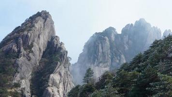 The beautiful mountains landscapes with the green forest and the erupted rock cliff as background in the countryside of the China photo