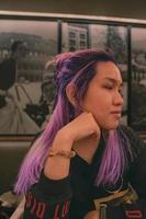 A woman with purple hair side view photo