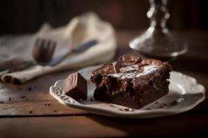 Delicious homemade chocolate brownie in white ceramic plate on rustic wooden table. . Selective focus photo