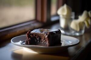 Delicious homemade chocolate brownie in white ceramic plate on rustic wooden table. . Selective focus photo